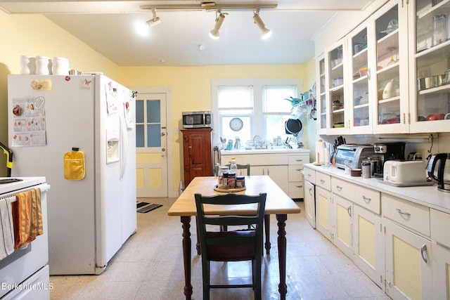 6-10 Manville St, Great Barrington, MA 01230 - kitchen with white appliances, light countertops, rail lighting, and glass insert cabinets