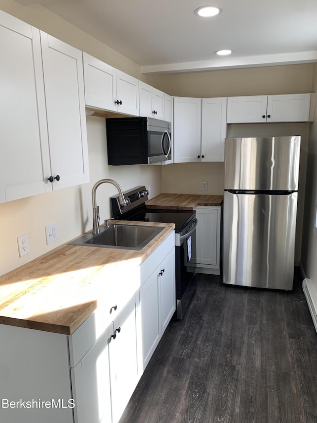 35 Main St, West Stockbridge, MA 01266 - kitchen featuring appliances with stainless steel finishes, wood counters, dark wood finished floors, white cabinetry, and recessed lighting