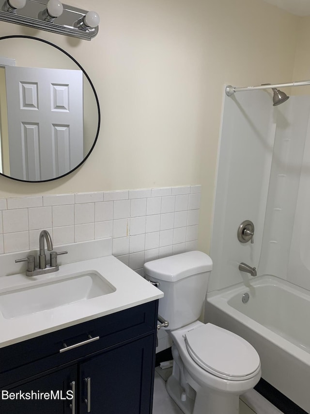 35 Main St, West Stockbridge, MA 01266 - bathroom with tile walls, toilet, shower / bathtub combination, vanity, and decorative backsplash