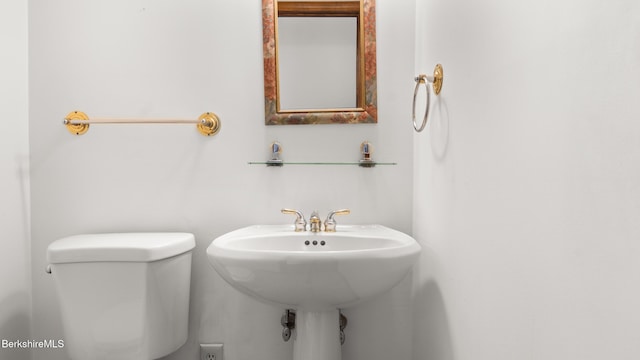bathroom with toilet and a sink