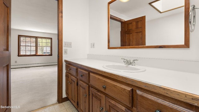 bathroom featuring a baseboard radiator, vanity, and a skylight