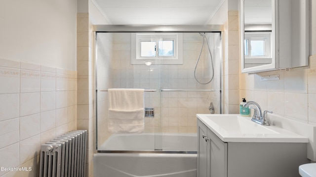370 Park St, Great Barrington, MA 01236 - bathroom featuring radiator, tile walls, vanity, enclosed tub / shower combo, and healthy amount of natural light