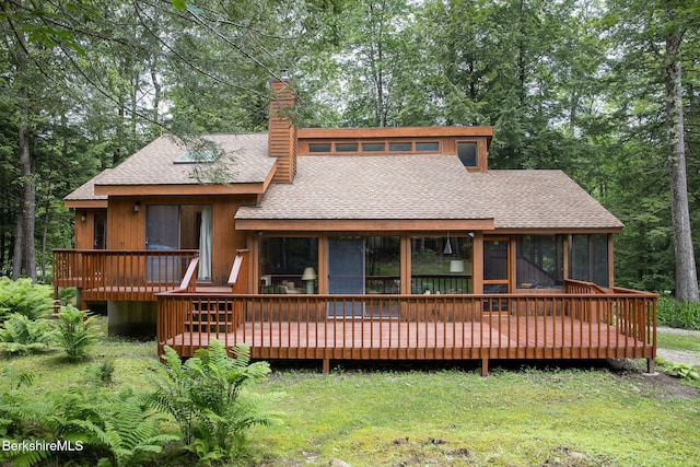 309 Tamarack Trl, Sandisfield, MA 01255 - rear view of house with a shingled roof, a sunroom, a chimney, a deck, and a lawn