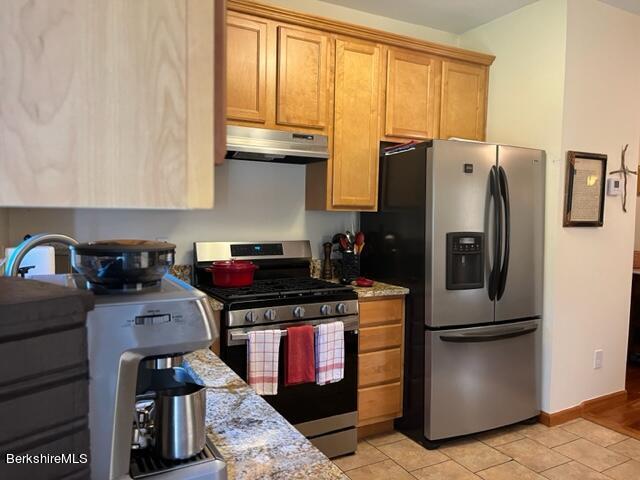 8 Stanley Dr Unit A-4, Great Barrington, MA 01230 - kitchen featuring appliances with stainless steel finishes, under cabinet range hood, light tile patterned floors, baseboards, and light stone counters