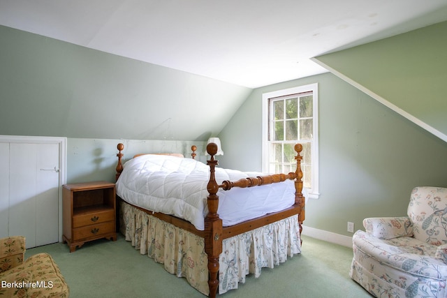 bedroom featuring light carpet and vaulted ceiling