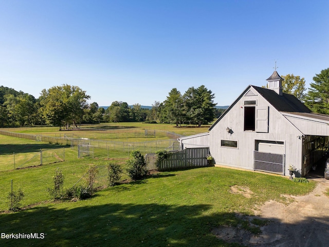 view of yard featuring an outbuilding and a rural view