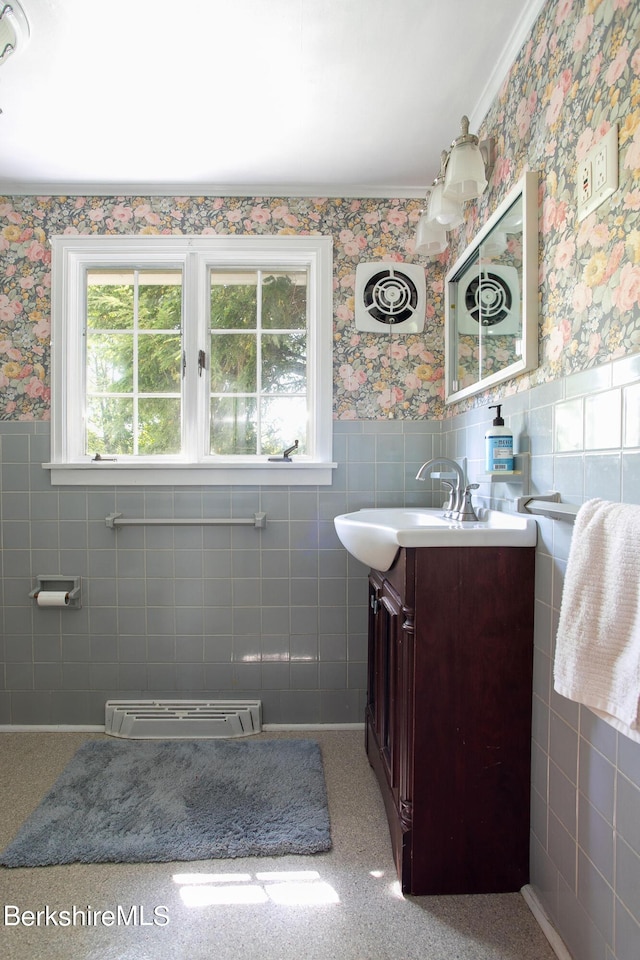 bathroom with vanity, tile walls, and ornamental molding