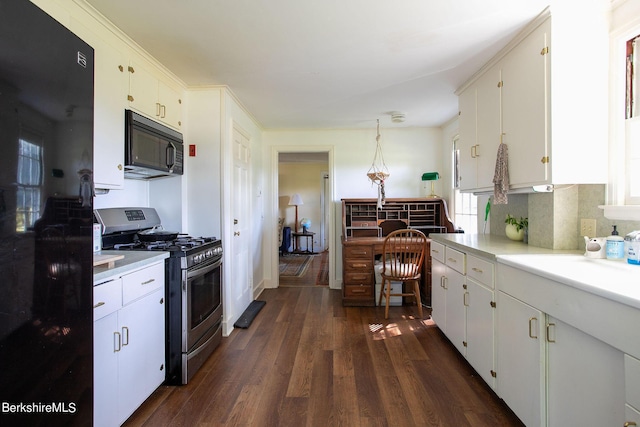 kitchen featuring black appliances, decorative light fixtures, and white cabinets