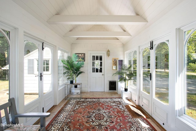 sunroom featuring lofted ceiling with beams and french doors