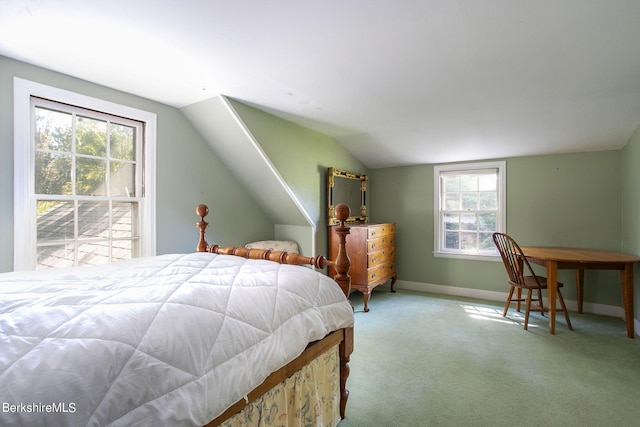 bedroom featuring multiple windows, light carpet, and lofted ceiling