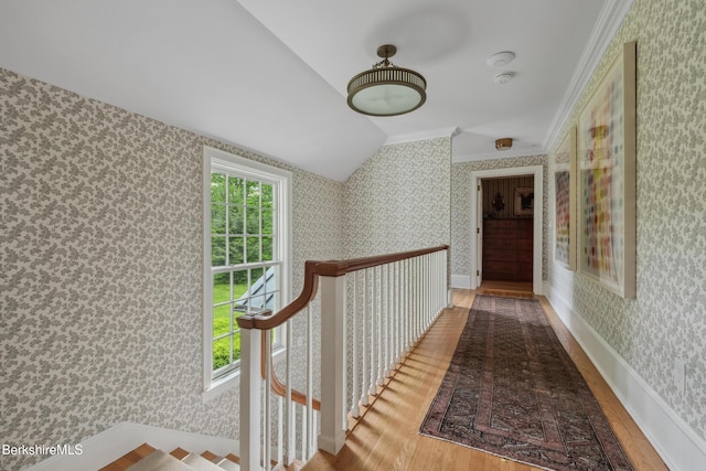 1030 W St, Pittsfield, MA 01201 - corridor featuring wood finished floors, wallpapered walls, lofted ceiling, ornamental molding, and an upstairs landing