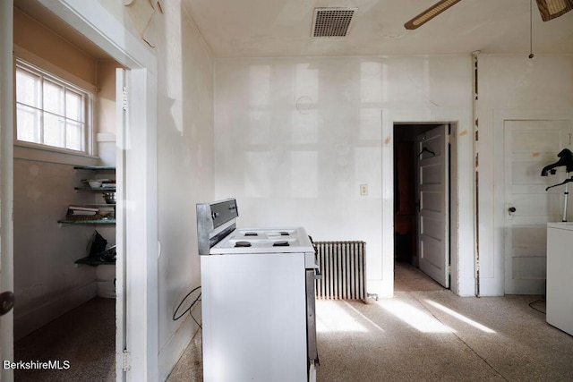 clothes washing area featuring light carpet, laundry area, visible vents, washer / clothes dryer, and radiator heating unit