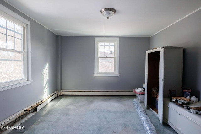 unfurnished bedroom with a baseboard heating unit