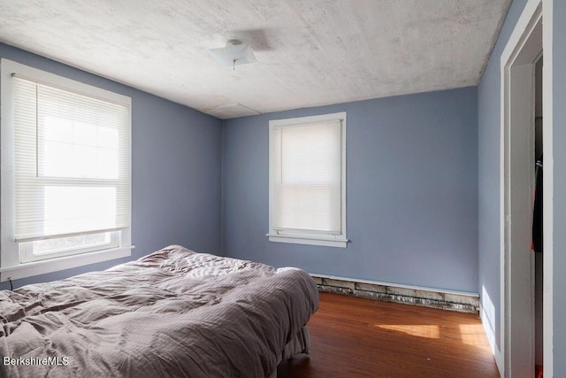 bedroom with wood finished floors