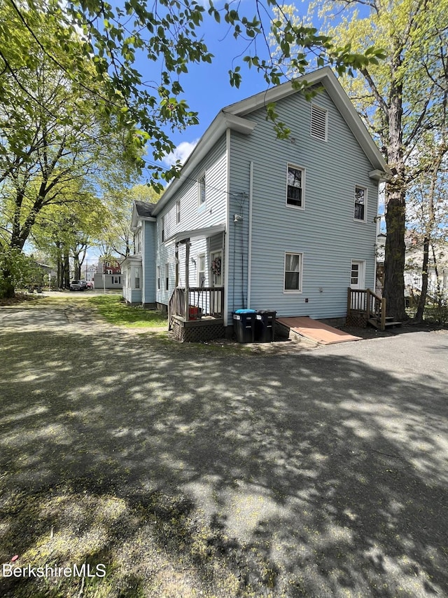 view of property exterior with a wooden deck