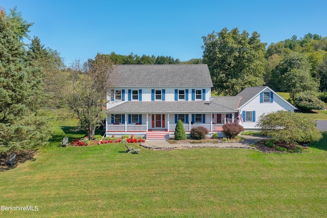 colonial house with a porch and a front lawn