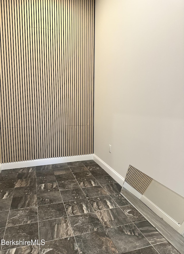 unfurnished room featuring baseboards
