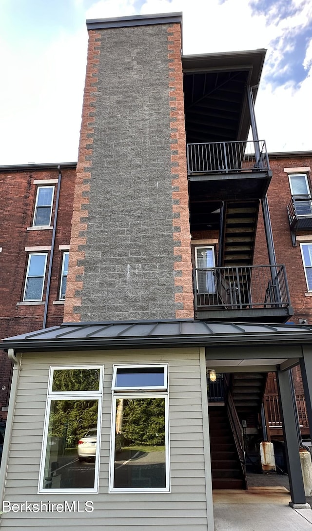 back of house featuring a balcony