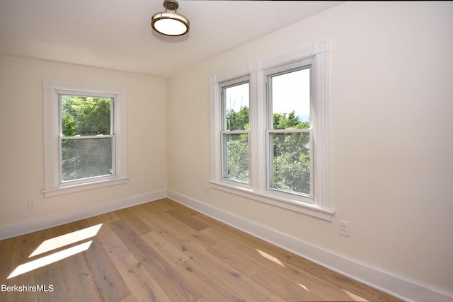 spare room with light wood-type flooring