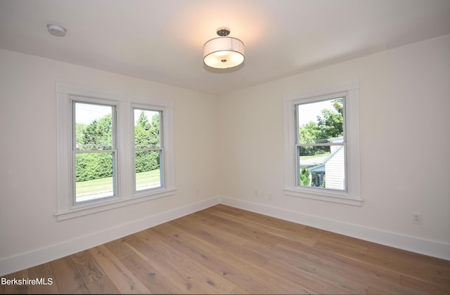 unfurnished room with light hardwood / wood-style flooring