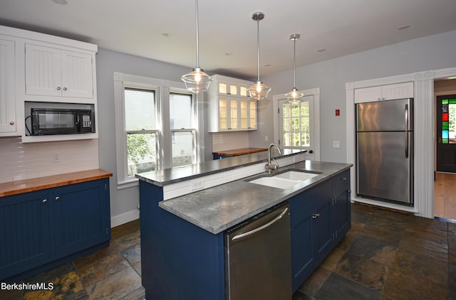 kitchen featuring sink, white cabinets, an island with sink, blue cabinetry, and appliances with stainless steel finishes