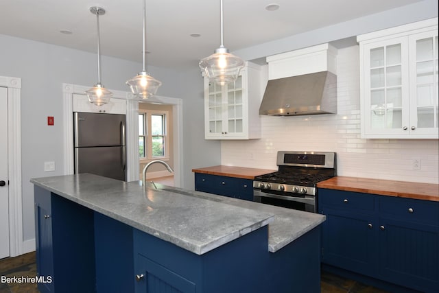 kitchen with stainless steel appliances, white cabinetry, and blue cabinets