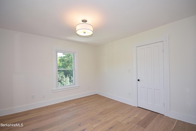 unfurnished room with light wood-type flooring