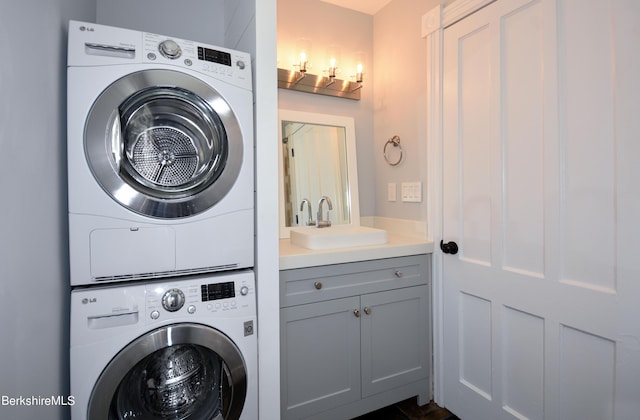 laundry area with sink and stacked washing maching and dryer