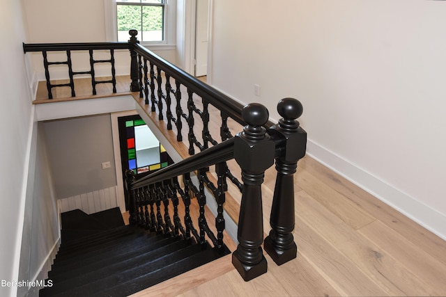 stairs with hardwood / wood-style floors