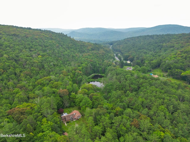 drone / aerial view with a mountain view and a wooded view