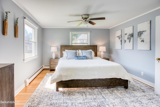 bedroom with ceiling fan, ornamental molding, light hardwood / wood-style floors, and a baseboard heating unit