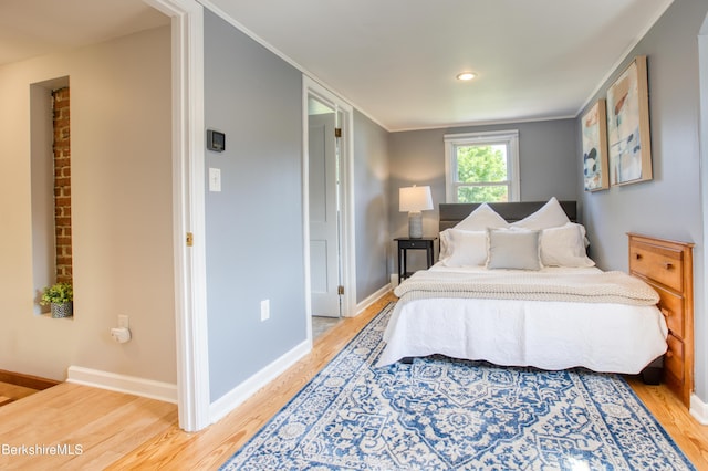 bedroom featuring hardwood / wood-style flooring and ornamental molding