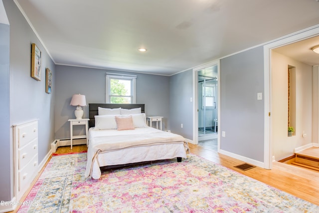 bedroom with light wood-type flooring, a baseboard radiator, and crown molding