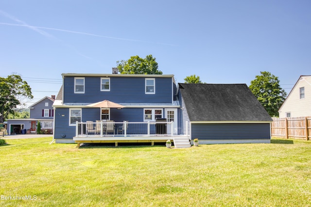 rear view of property with a yard and a wooden deck