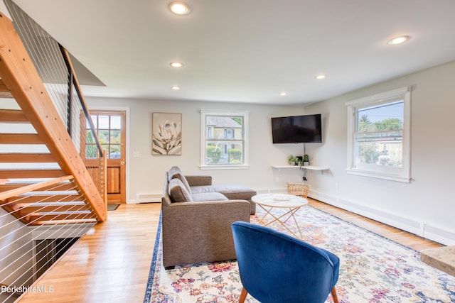 living room with a baseboard radiator and hardwood / wood-style flooring