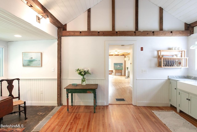 649 Hewins St, Sheffield, MA 01257 - kitchen with a wainscoted wall, light wood finished floors, high vaulted ceiling, and wood ceiling with exposed beams