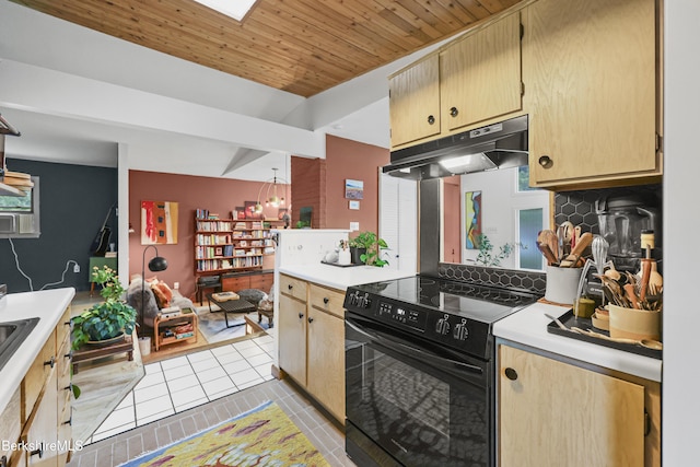 72 Cleveland St, Pittsfield, MA 01201 - kitchen with black / electric stove, under cabinet range hood, light tile patterned flooring, backsplash, and light countertops