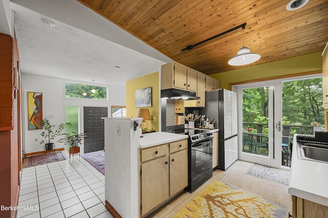 72 Cleveland St, Pittsfield, MA 01201 - kitchen with black electric range, a peninsula, under cabinet range hood, light tile patterned flooring, and freestanding refrigerator