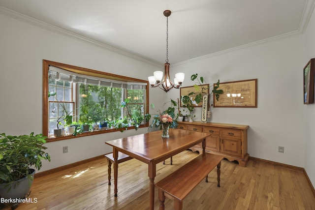 67 Dunmore Ct, Lenox, MA 01240 - dining space featuring a chandelier, crown molding, and light wood finished floors