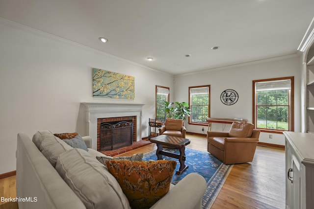 67 Dunmore Ct, Lenox, MA 01240 - living area with crown molding, a brick fireplace, light wood-style flooring, and recessed lighting