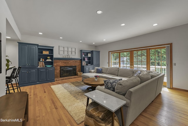 67 Dunmore Ct, Lenox, MA 01240 - living area with a brick fireplace, light wood-style floors, and recessed lighting