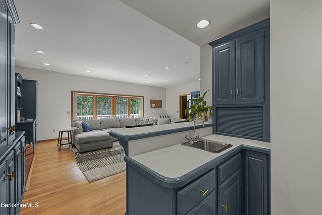 67 Dunmore Ct, Lenox, MA 01240 - kitchen featuring light wood finished floors, open floor plan, recessed lighting, light countertops, and a peninsula