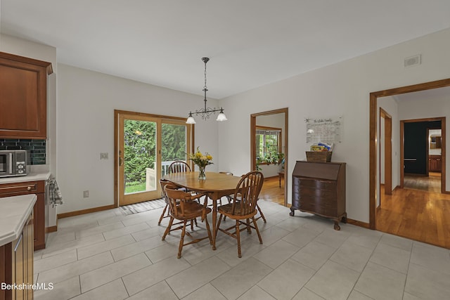 67 Dunmore Ct, Lenox, MA 01240 - dining space featuring a chandelier and light tile patterned floors