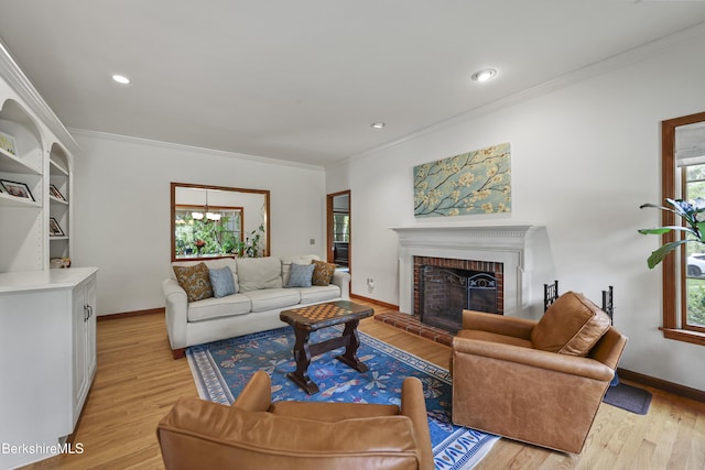 67 Dunmore Ct, Lenox, MA 01240 - living room with light wood-style flooring, ornamental molding, a brick fireplace, and recessed lighting