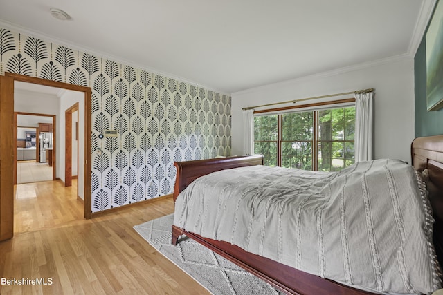 67 Dunmore Ct, Lenox, MA 01240 - bedroom featuring ornamental molding, wallpapered walls, wood finished floors, and an accent wall