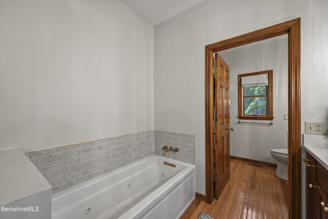 67 Dunmore Ct, Lenox, MA 01240 - full bathroom with a tub with jets, vanity, and hardwood / wood-style floors