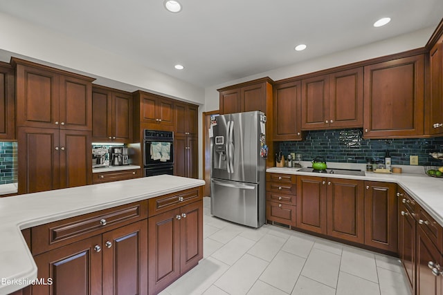 67 Dunmore Ct, Lenox, MA 01240 - kitchen featuring black appliances, light countertops, backsplash, light tile patterned floors, and recessed lighting