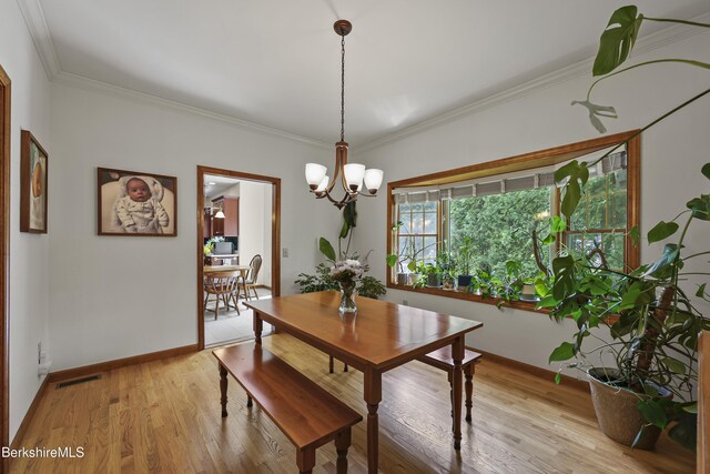 67 Dunmore Ct, Lenox, MA 01240 - dining area with a chandelier, light wood finished floors, and crown molding