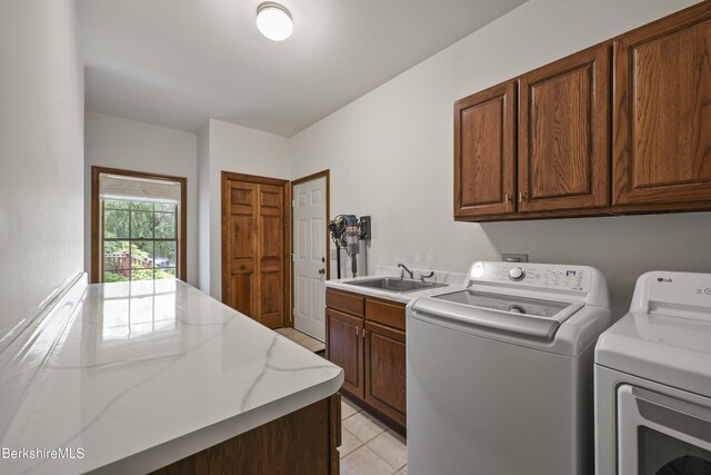 67 Dunmore Ct, Lenox, MA 01240 - laundry area featuring cabinet space, independent washer and dryer, and light tile patterned floors