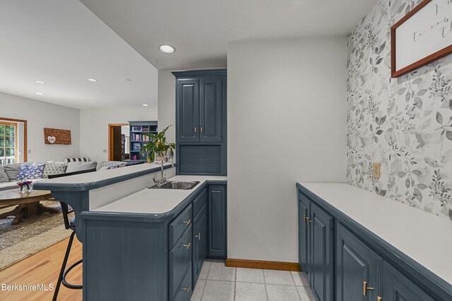 67 Dunmore Ct, Lenox, MA 01240 - kitchen with a peninsula, a breakfast bar area, light countertops, open floor plan, and recessed lighting